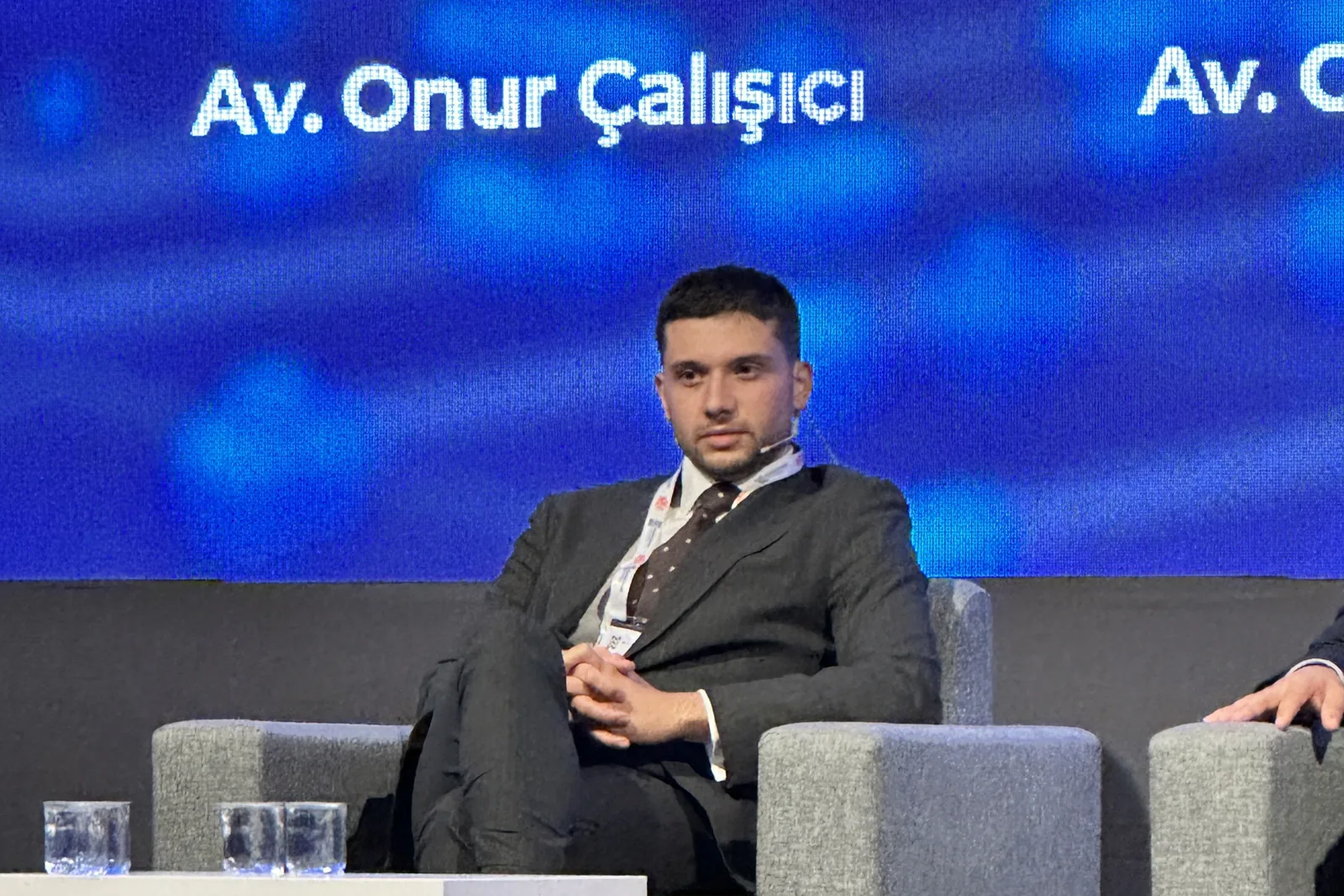 Av. Onur Çalışıcı speaking on a conference panel in Istanbul